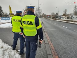 na zdjęciu policjanci z drogówki stoją przy drodze